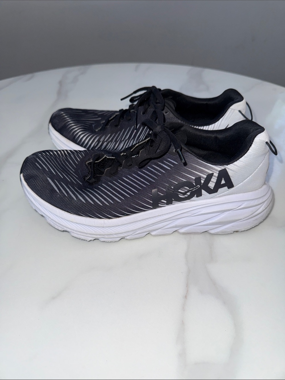 Hoka women’s Black and White Neutral Cushion Running Shoes